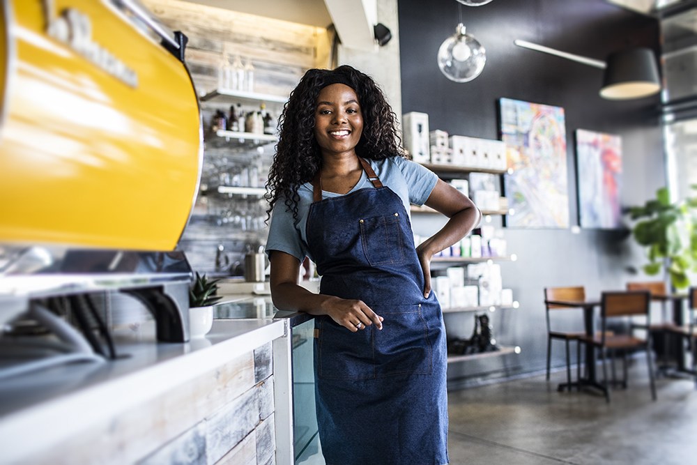 Black woman small business owner standing in her coffee shop