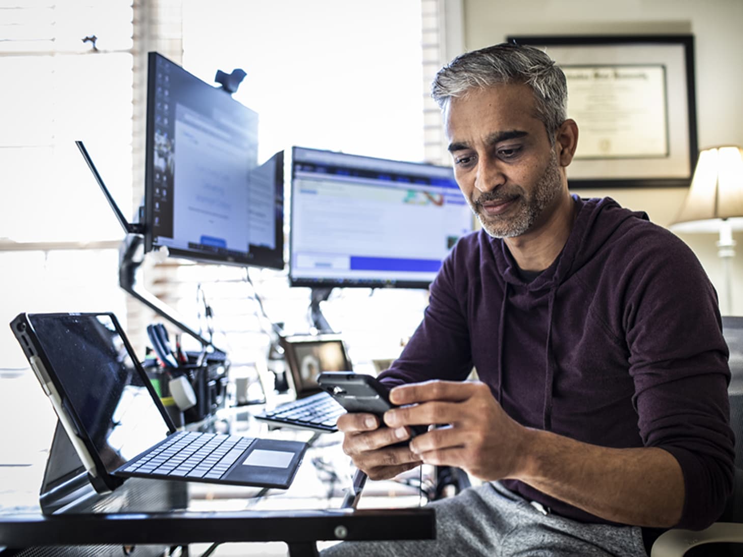 man working on multiple devices 