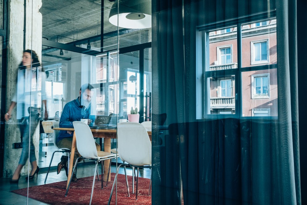 Reflection of man and woman in workplace office
