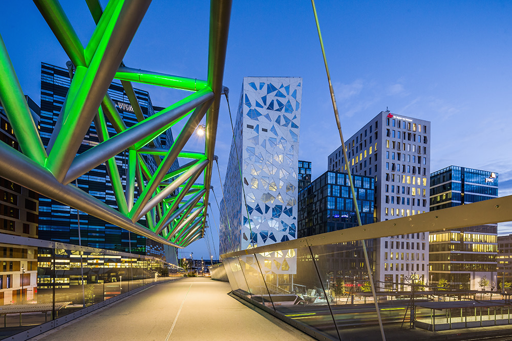 bridge walkway going into a city