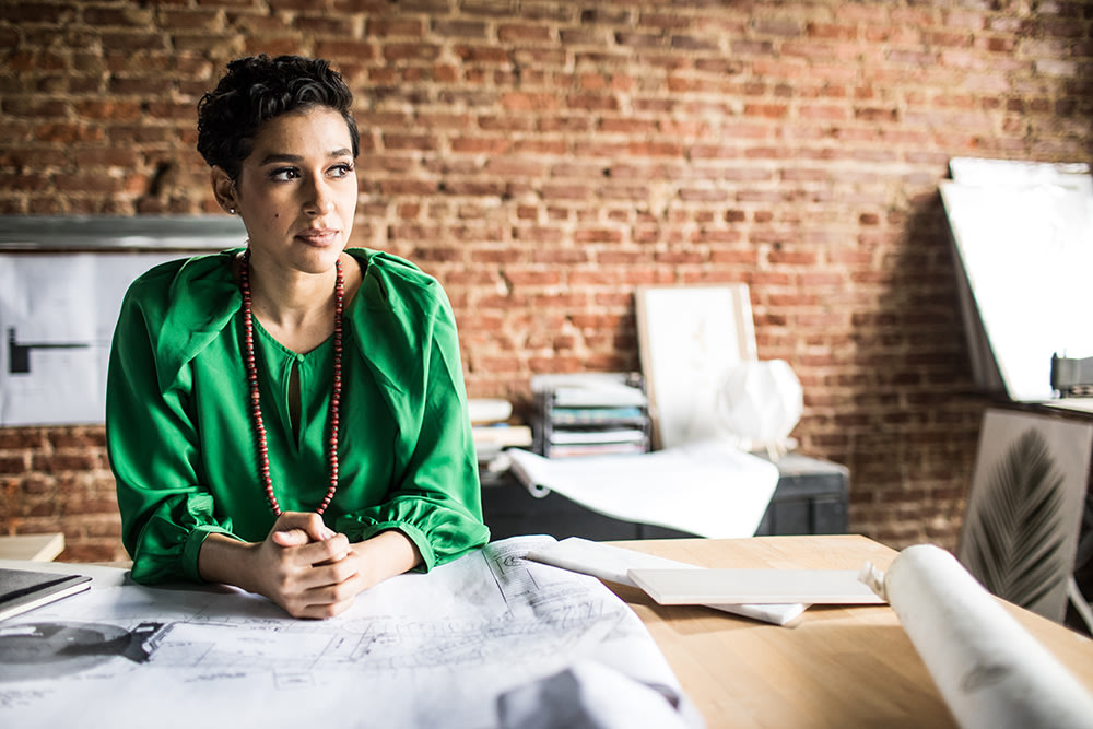 Woman in green shirt sitting at her desk