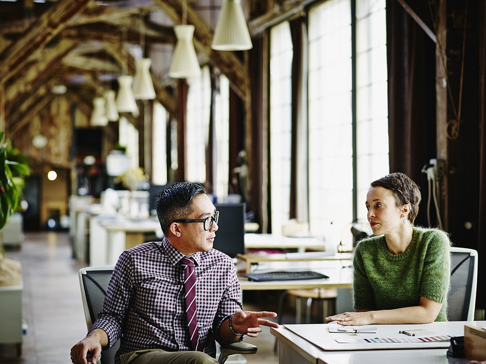 Man and woman in office talking