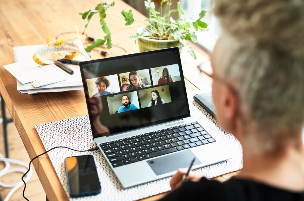man on a video call with colleagues