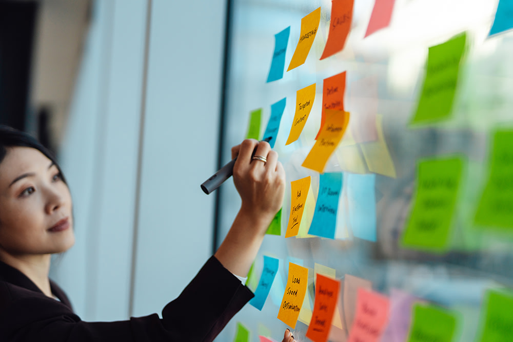 Woman writing on sticky notes