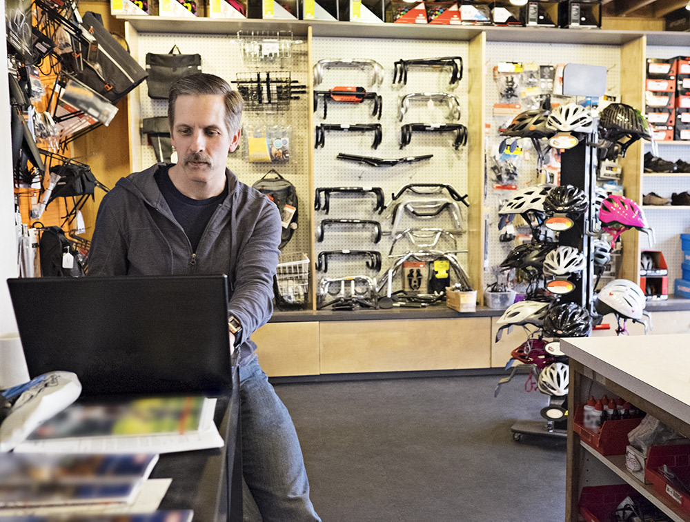 Man sitting in bicycle shop