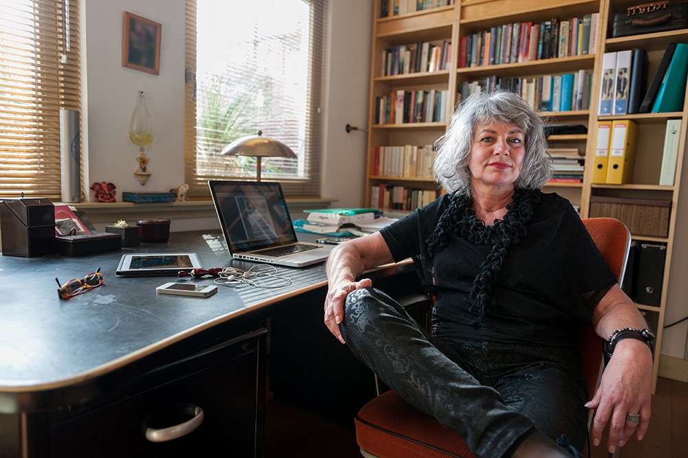 Woman in black sitting in front of her laptop