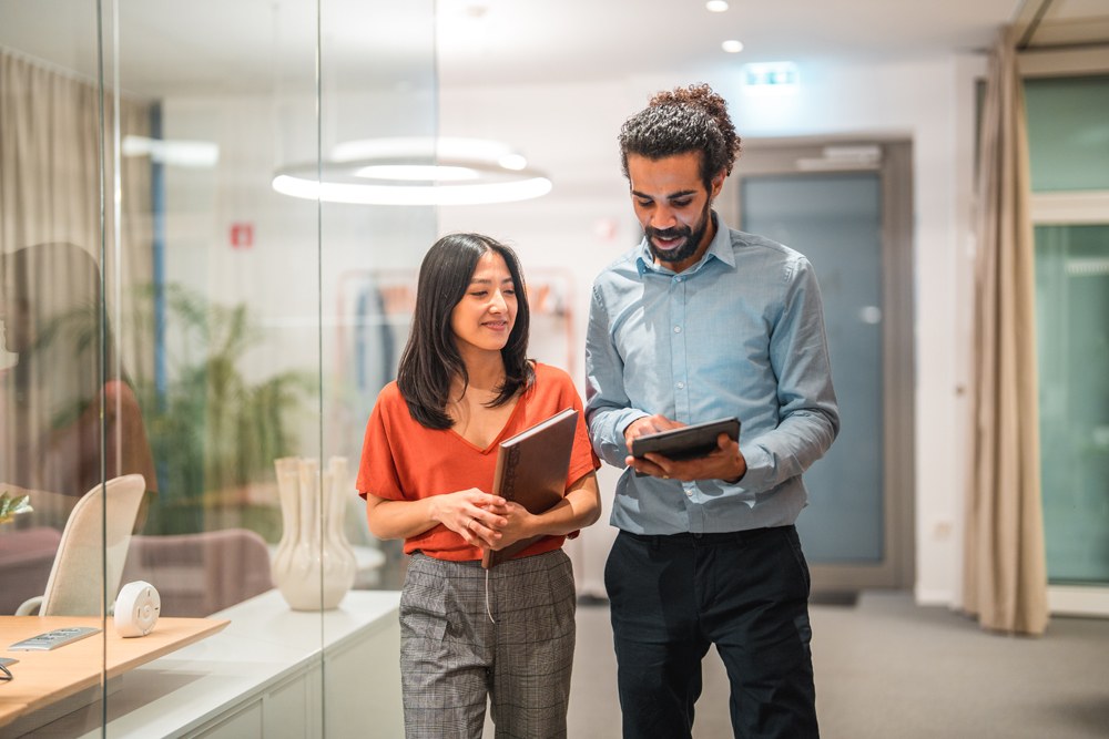 Employees walking and talking with tablets