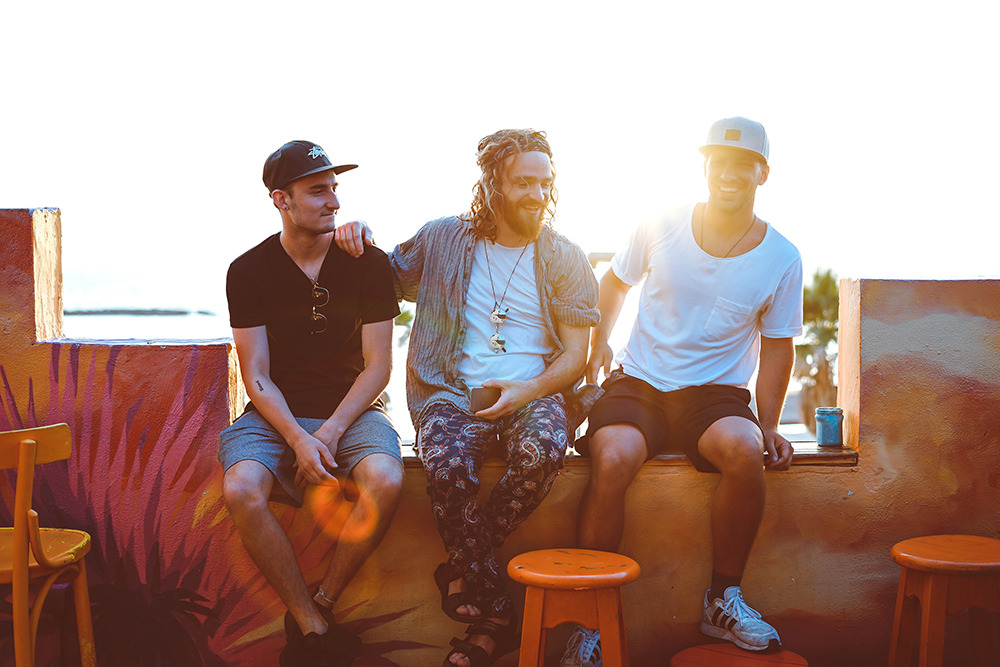 Three men smiling