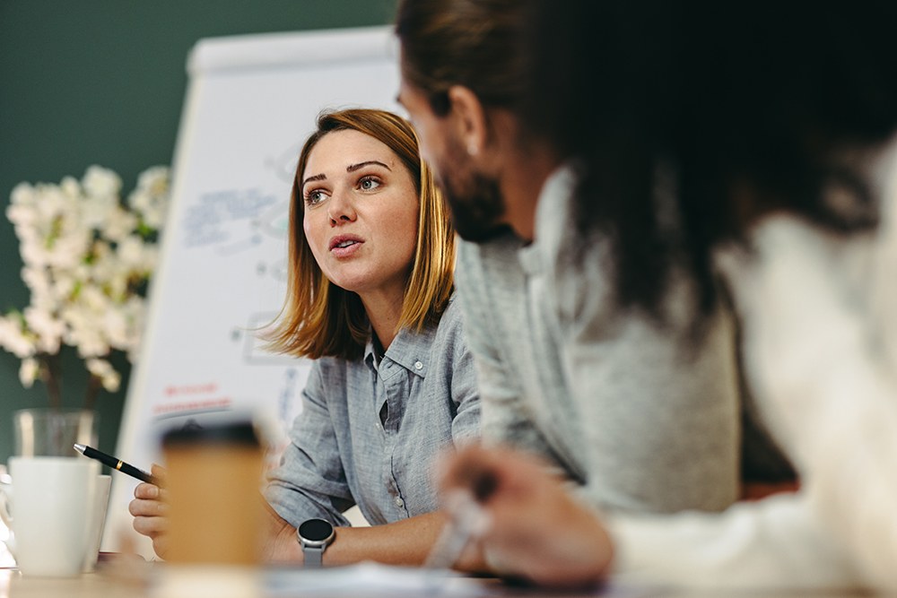 Two employees sitting at the table talking